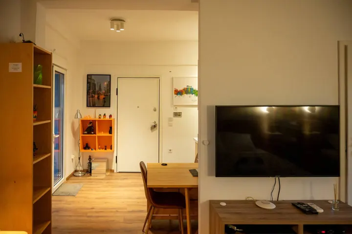 Open-plan dining area, entry, and television