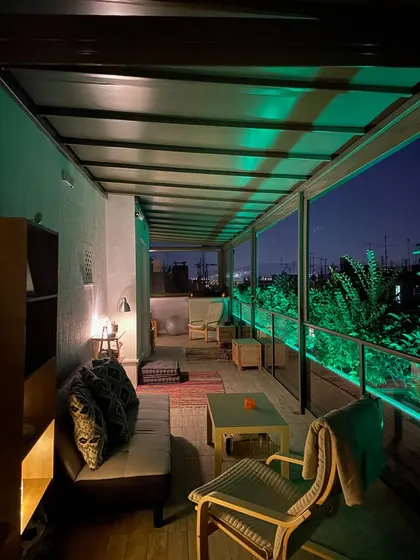 Large covered terrace with evening lighting