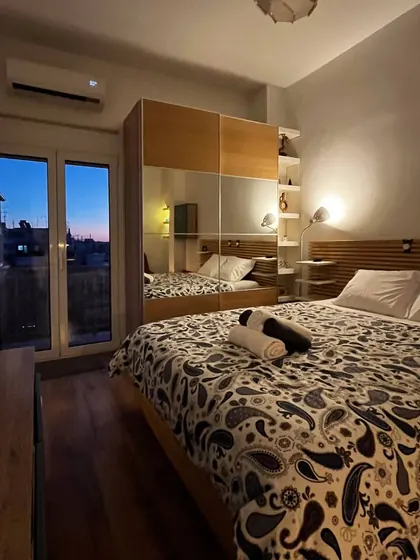 Bedroom with balcony doors and bedside lighting