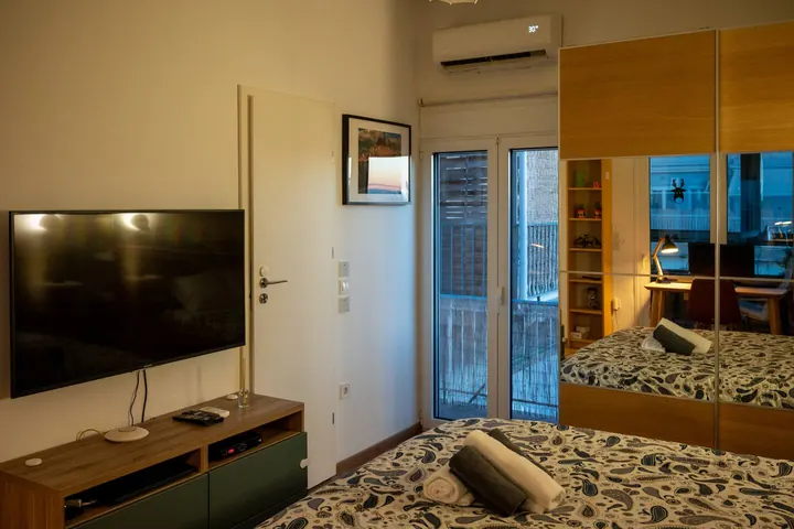 Bedroom, television, and balcony doors