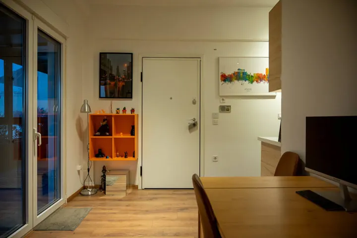Apartment entrance, dining area, and television