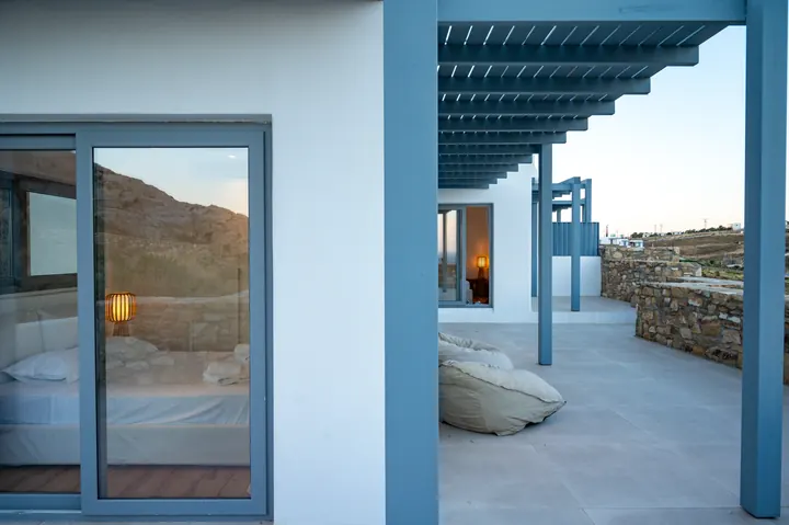 Modern shaded terrace with indoor-outdoor flow and serene hillside views