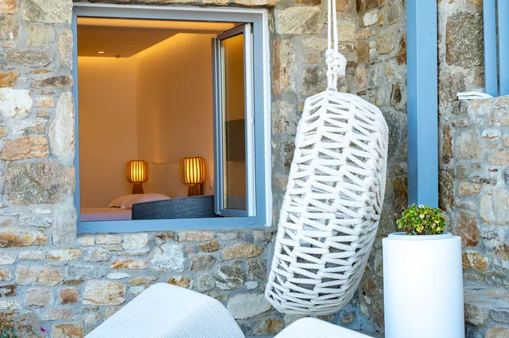 Rustic stone exterior with cozy bedroom views and stylish outdoor accents