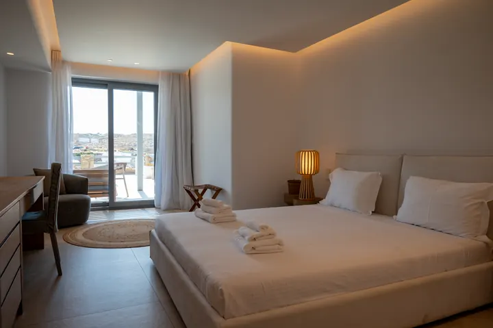 Bright modern bedroom with balcony views and warm ambient lighting