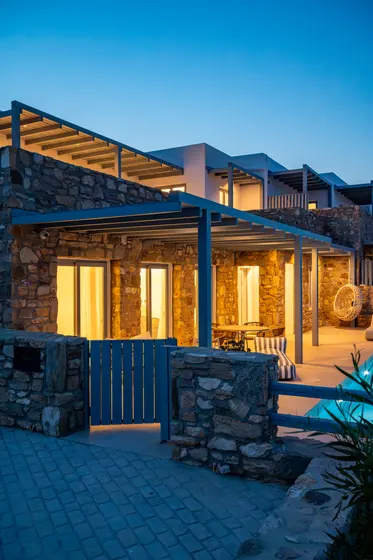 Elegant stone villa with glowing patios and chic outdoor lounge space