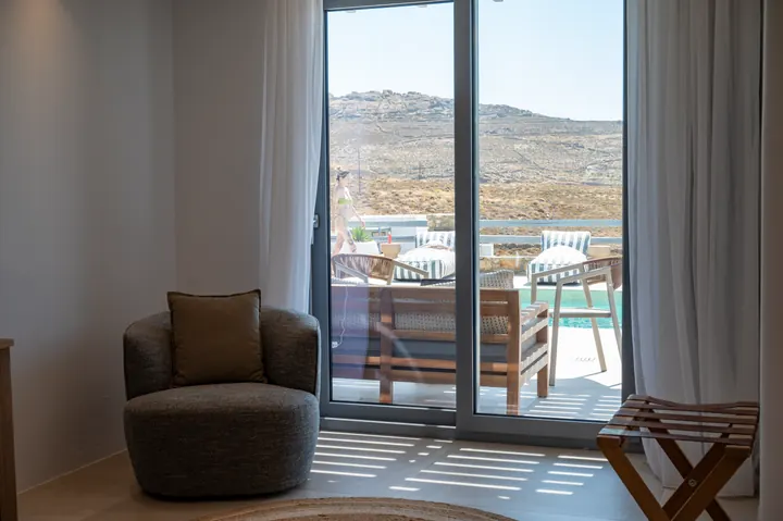 Bright room with private terrace seating and scenic hillside views