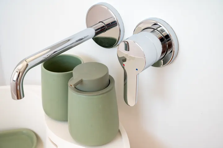 Modern spa-style bathroom with sleek wall-mounted fixtures
