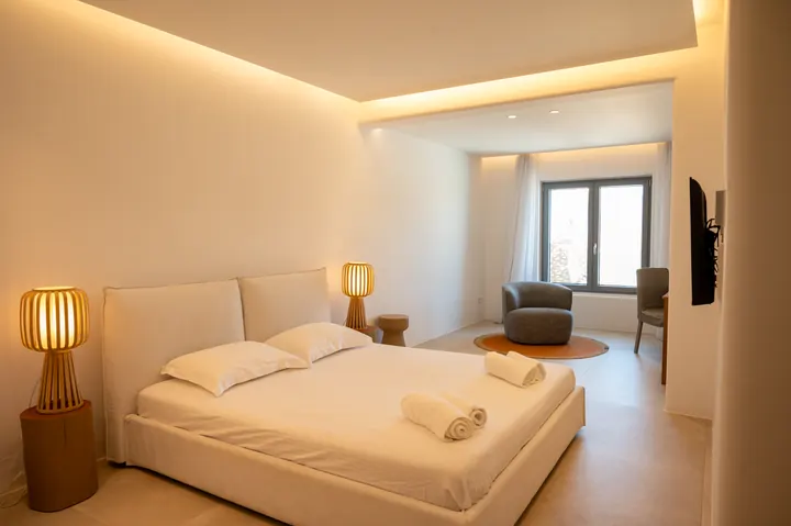 Serene modern bedroom with ambient lighting and cozy window seating