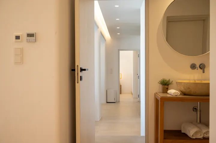 Bright modern entry with spa-style vanity and elegant minimalist design