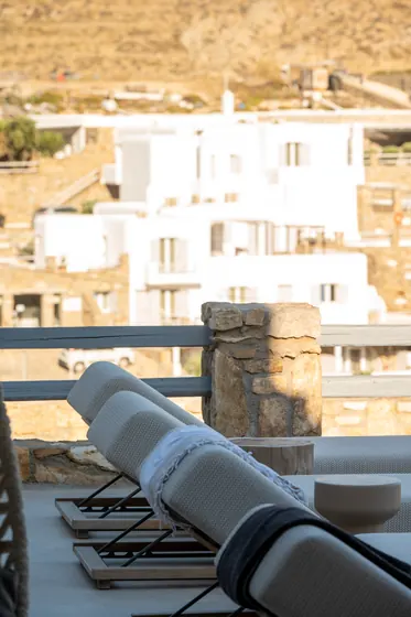 Sun-soaked terrace with loungers and charming hillside views