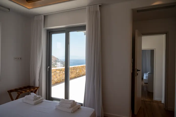Serene bedroom with private terrace and stunning sea views