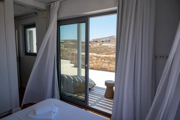Bright bedroom with private terrace and peaceful hillside views