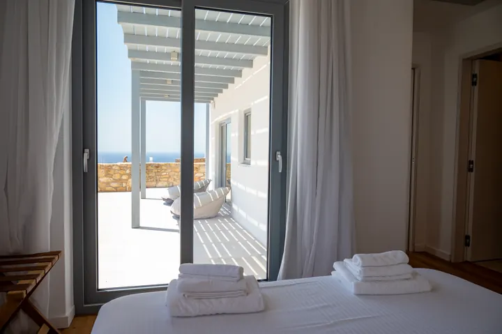 Bright bedroom with private terrace, pergola lounge, and sea views