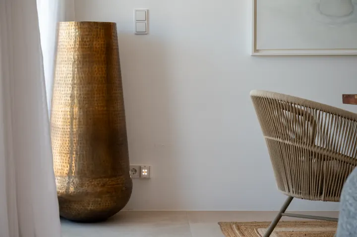 Sunlit designer corner with woven seating and elegant decor