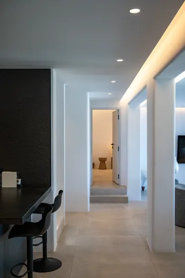 Sleek modern hallway with breakfast bar and soft ambient lighting