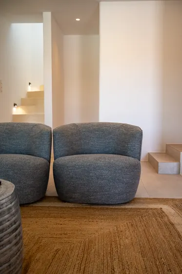 Minimalist lounge with plush seating and elegant split-level design