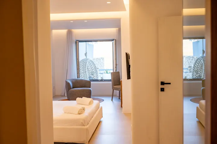 Bright modern suite with cozy seating and a stylish hanging chair