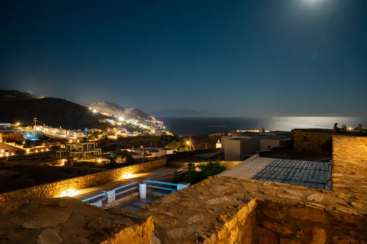 Moonlit sea views and glowing hillside village from the terrace
