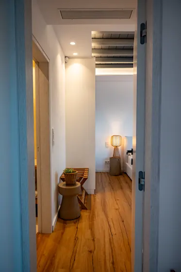 Warm modern hallway with wood floors and cozy ambient lighting