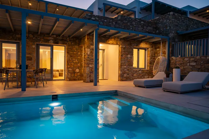 Private plunge pool terrace with chic loungers and glowing evening ambiance