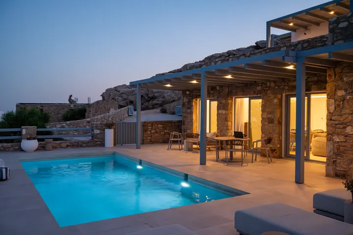 Private pool oasis with chic patio dining and glowing sunset ambiance