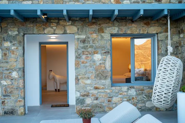 Rustic stone patio with cozy lounge seating and warm mountain-view charm