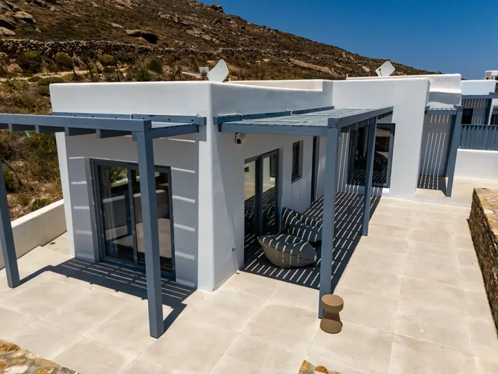 Modern villa terrace with pergola shade and scenic hillside views